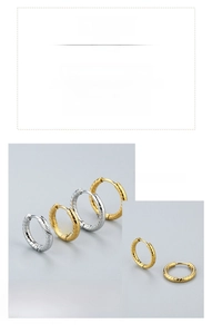 Detailed macro view of spiral twisted stainless steel hoop earrings in gold and silver