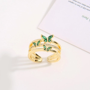 Detail of gold-plated brass ring with green zircon butterflies and micro-pave crystals