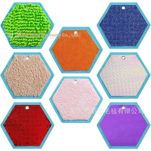 Detail of eight textured hexagonal tactile sensory pads for kids with diverse fabric surfaces