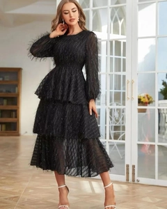 Detail of elegant black tiered maxi dress with unique fringe texture and long sleeves