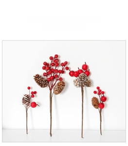 Close-up of artificial red berries and pine cones for Christmas floral arrangements