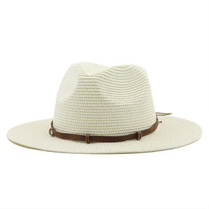 Detail of light beige woven straw cowboy hat with a brown faux leather belt and buckle