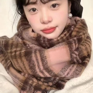 Detailed close-up of brown plaid scarf texture and soft synthetic cashmere material