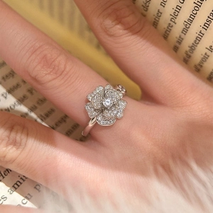 Sparkling zircon camellia flower ring in silver finish worn on finger for women