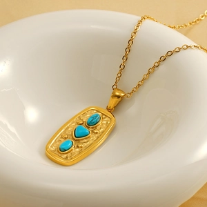 Vintage gold plated stainless steel necklace with heart turquoise pendant in white bowl