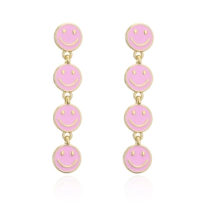 Macro detail of gold-plated pink enamel smiley face drop earrings with vertical link design