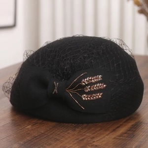 Detail of wool beret featuring mesh veil, large bow, and exquisite wheat-ear beaded accents