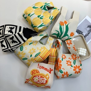 Flat lay of knit tote bags featuring colorful tulip and daisy floral patterns