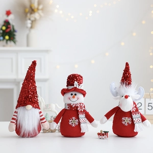 Close-up of Santa gnome, snowman, and reindeer plush ornaments with red sequins and scarves