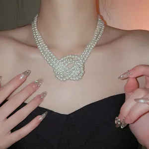 Elegant triple-layered knotted pearl necklace for women featuring cream white beads