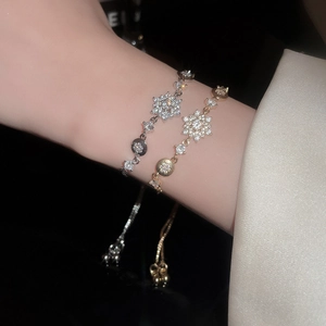 Macro detail of snowflake charm bracelets with cubic zirconia and adjustable slide clasps