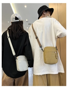 Detail view of white and khaki nylon crossbody bags with adjustable wide straps on models
