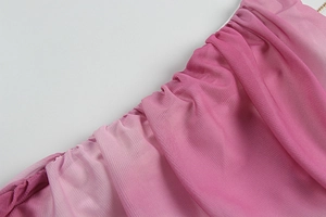 Detailed view of pink purple mesh fabric with ruched texture and gold metal chain strap