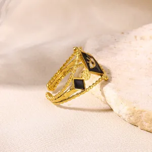 Macro detail of Bohemian gold-plated evil eye open ring on textured stone
