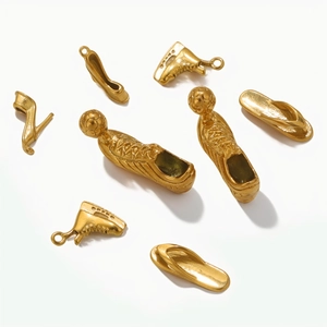 Detailed close-up of 3D gold stainless steel shoe charms for DIY jewelry making