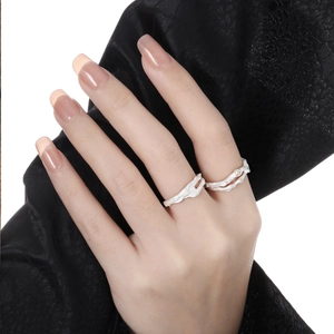 Artistic silver twig ring set with micro-inlaid diamonds on silk fabric background