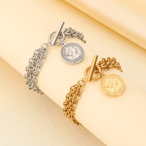 Detail of layered stainless steel portrait coin bracelets with OT buckle in gold and silver