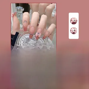 Detail of pink purple gradient press-on nails with 3D bows and heart rhinestones