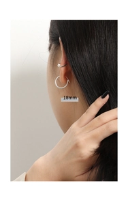 Close-up of 18mm sterling silver hoop earring with minimalist polished finish on model