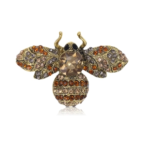 Vintage gold crystal bee brooch with amber rhinestones on a clean white background