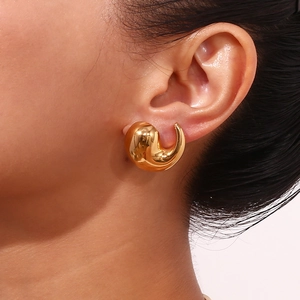 Close-up of 18K gold plated chunky teardrop earrings showing mirror polish on model