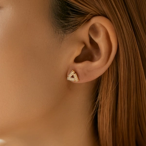 Geometric triangle zircon stud earrings in 18K gold finish worn by a model