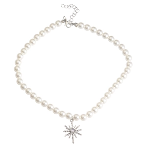 Close-up of pearl necklace featuring a silver starburst pendant with an opal gemstone