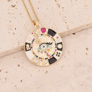 Golden evil eye pendant necklace with colorful zircons and lucky charms on beige stone
