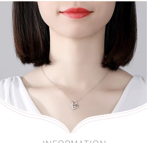 Close-up of S925 sterling silver heart pendant necklace with crystal on model