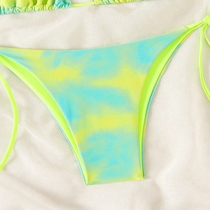 Detail of neon green and blue tie-dye bikini bottoms with adjustable side ties