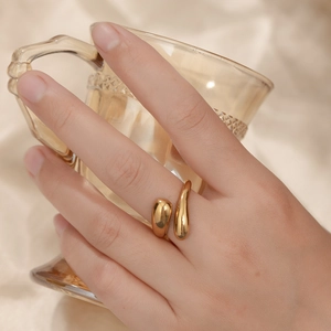 Minimalist gold adjustable open ring featuring an irregular fluid water drop design on hand
