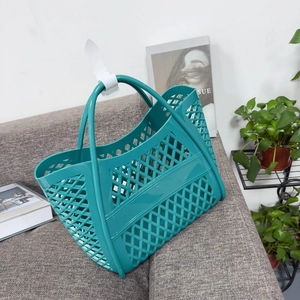Close-up of a teal hollow silicone basket featuring a diamond mesh pattern on a sofa