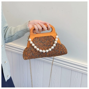 Detail of tweed evening bag featuring a natural wooden handle and pearl chain accessory