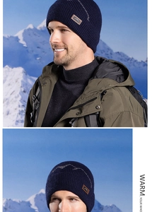 Close-up of ribbed knit beanie with mountain logo patch worn with outdoor jacket