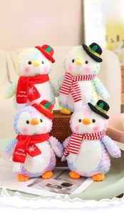 Detail of colorful tie-dye Christmas penguin plushies with hats and striped scarves
