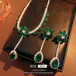 Vintage jewelry set with emerald zircon flower pendant and matching dangle earrings