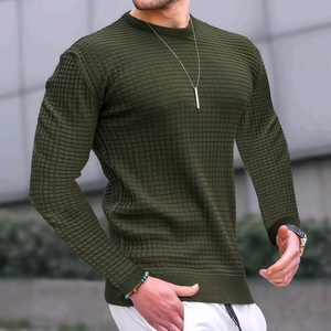 Close-up of olive green slim fit sweatshirt featuring waffle knit texture and crew neck detail