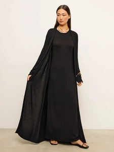 Full-body shot of a chic black knit long sleeve cardigan and matching maxi dress set