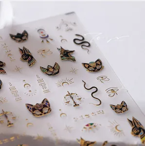 Macro detail of 3D embossed gold Egyptian nail art stickers with Anubis and Horus eye