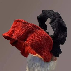 Elegant red and black knitted headband with textured pleats for a vintage winter style