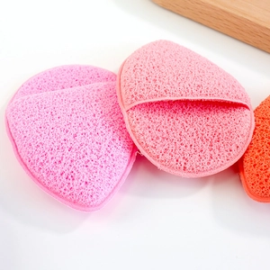 Thick pink and orange facial cleansing sponges with finger pocket for deep cleaning
