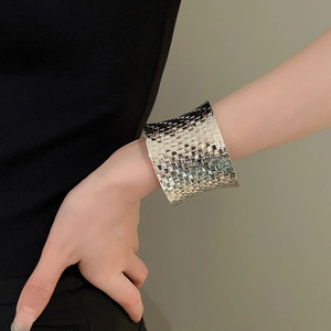 Macro detail of silver woven texture on wide open metal cuff bracelet for women
