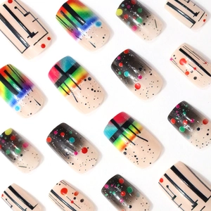 Artistic press-on nails featuring rainbow gradients, geometric lines, and colorful dots patterns