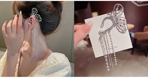 Detail of silver needle butterfly tassel earrings with pearls and rhinestones