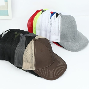 Stacked collection of breathable mesh trucker hats with curved brims in various colors