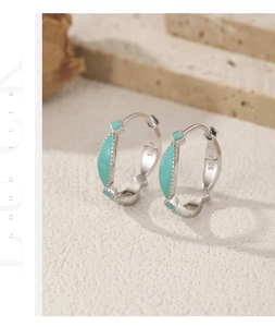 Detail view of S925 sterling silver stamp on minimalist turquoise enamel hoop earrings