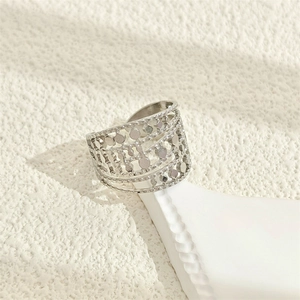 Minimalist silver hollow geometric stainless steel wide open ring on a textured base