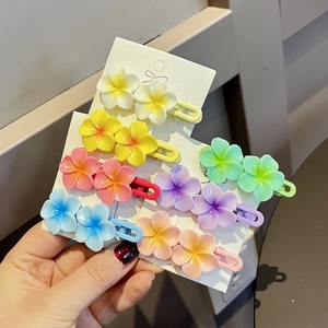 Colorful floral frangipani hair clips set with seven pastel colors on white card