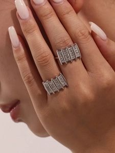 Close-up of geometric silver rings with zircon pavé setting and industrial column design