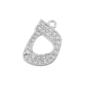 Macro detail of silver Arabic letter Ha pendant encrusted with sparkling cubic zirconia
